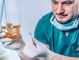 dentist explaining how a dental implant will be inserted