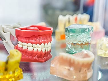 set of dentures on glass table