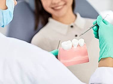 dentist explaining dental implant procedure to patient