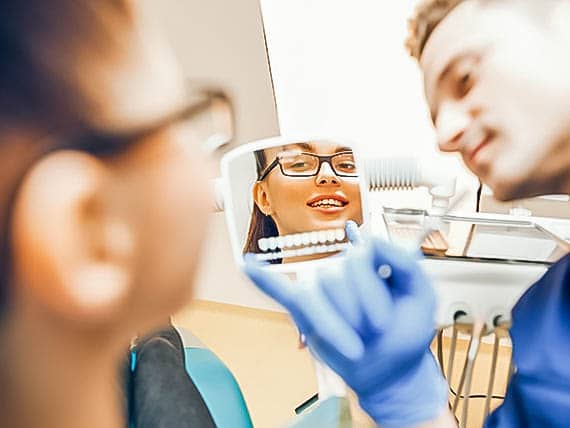 dentist showing patient their new smile