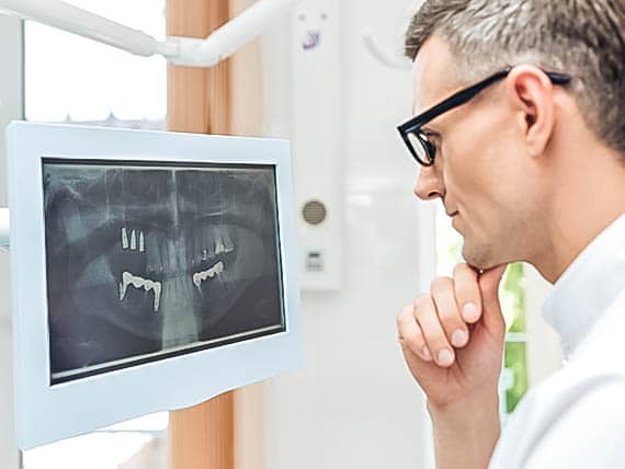 dentist reviewing a dental x-ray