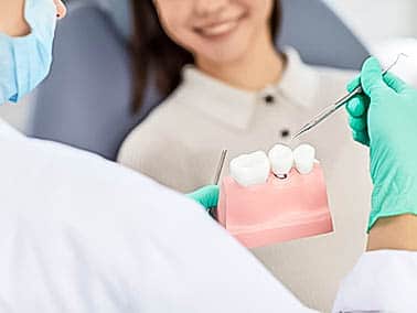 dentist explaining bridge procedure to patient