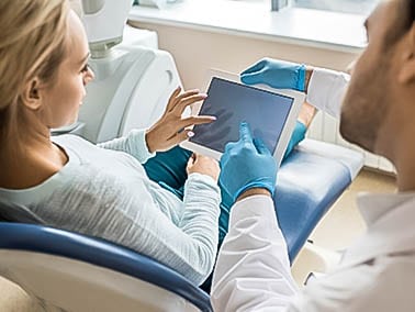 patient receiving dental consultation with cosmetic dentist