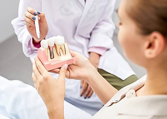 dentist explaining dental implants to patient