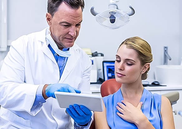 dentist going over cosmetic dental plan with patient