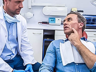 Patient consulting with dentist about tooth pain