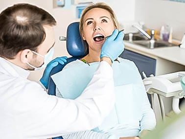 dentist checking patients teeth during dental check up