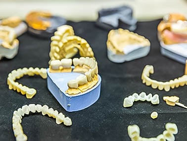 dentures laid out on a black surface
