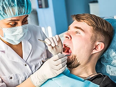 stressed out man getting dental work done