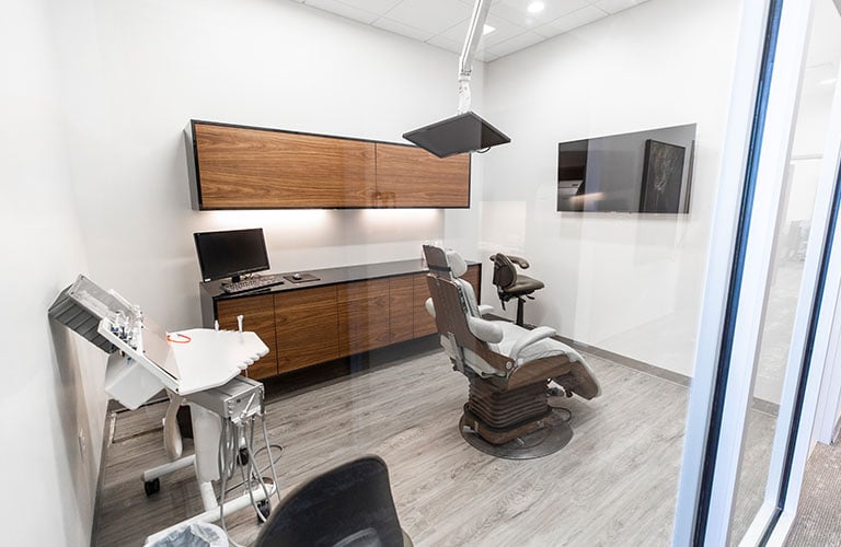 dental patient chair facing tv in treatment room at arete smile design