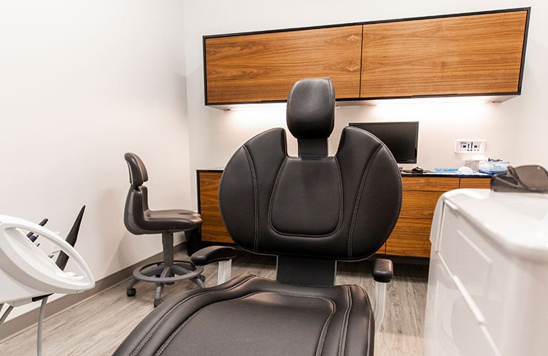 black patient chair in dental treatment room