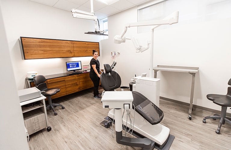 dental technician preparing treatment room for a dental cleaning
