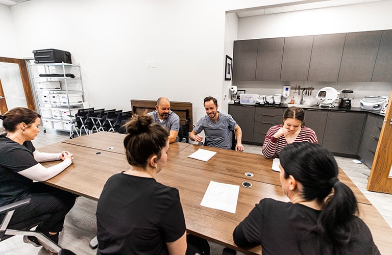 arete smile design staff sitting in office break room